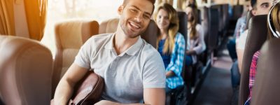 young-man-is-holding-his-brown-backpack-min-scaled
